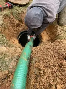 Professional septic pumping service removing buildup from tank