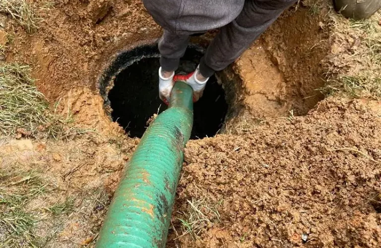 Professional septic pumping service removing buildup from tank