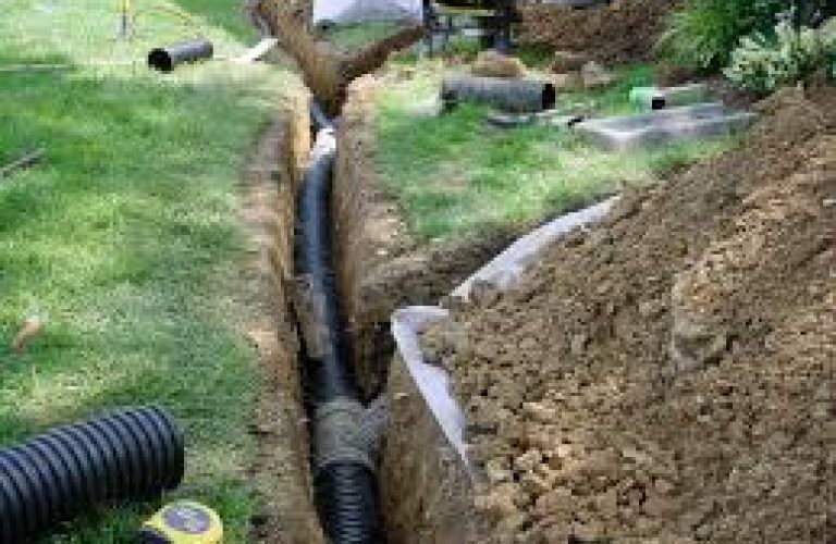 Installing drainage pipes to improve wastewater flow and prevent water buildup
